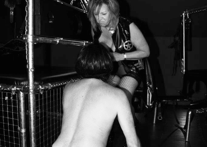 B&W Image of Mistress Orchid dominating a man in County Durham Dungeon